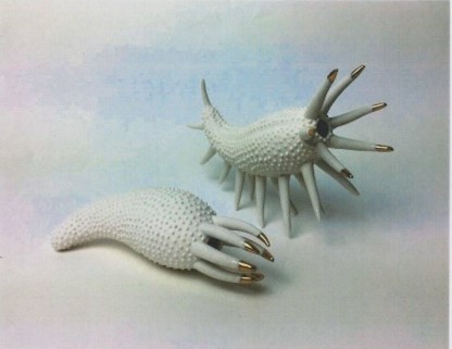 Two white sea creature skeletons looking like shells with bone tentacles. The end of every tentacle is painted gold so it looks like a claw.