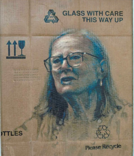 On recycled cardboard which still bears the printed instructions Glass with care This way up, most of the word Bottles, and Please recycle, is painted a head and shoulders portrait of a woman with shoulder length hair wearing glasses and speaking to someone on the left.